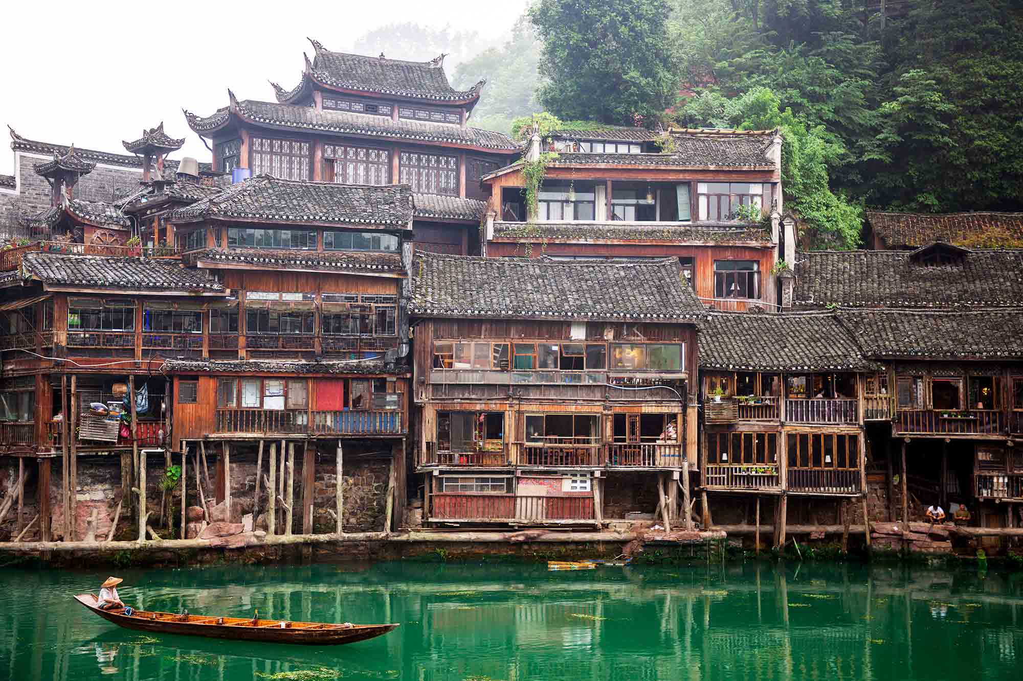 Fenghuang Ancient Town, is situated on the western boundary of Hunan Province in an area of outstanding natural beauty where mountains, water and blue skies prevail. 'Fenghuang' is Chinese for 'Phoenix', the mythical bird of good omen and longevity that is consumed by fire to be re-born again from the flames. Phoenix Ancient Town is so called as legend has it that two of these fabulous birds flew over it and found the Fenghuang Town so beautiful that they hovered there, reluctant to leave. © ULLI MAIER & NISA MAIER